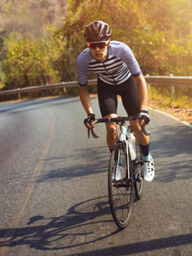 Asian men are cycling road bike in the morning.He is on a forest road.
