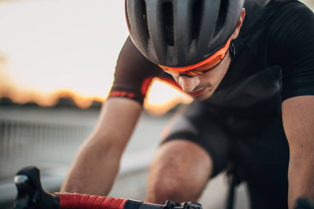 One man, professional cyclist riding his bicycle on the road alone.
