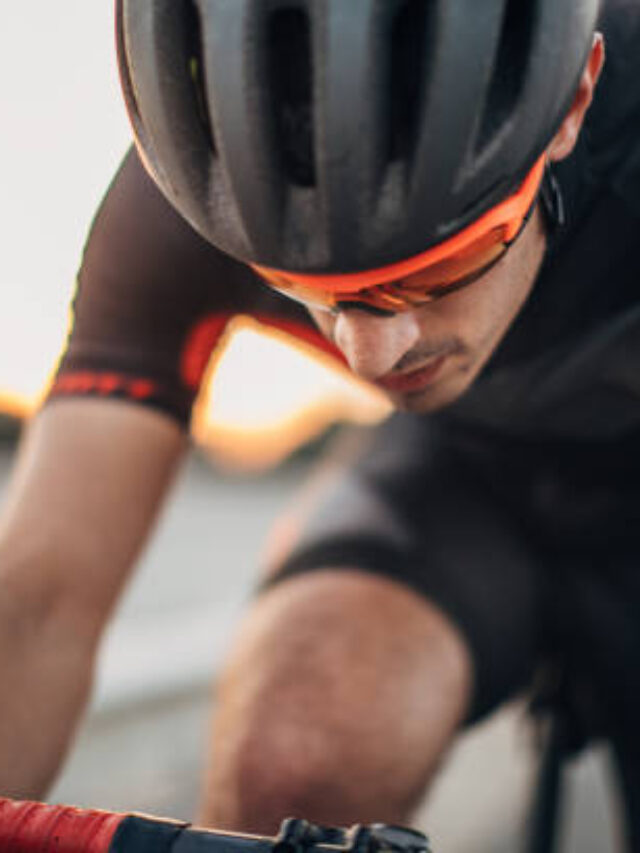 One man, professional cyclist riding his bicycle on the road alone.