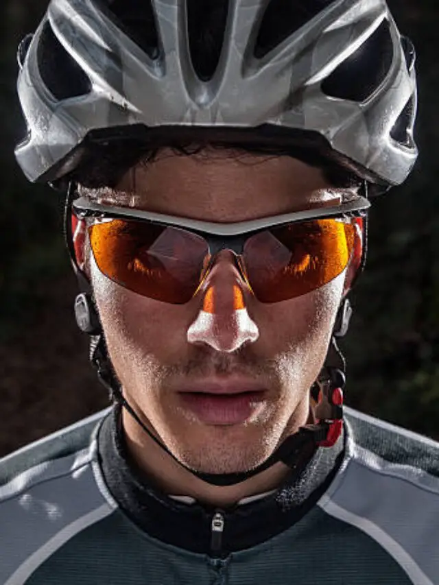 Cyclist portrait with flash light in a forest outdoors